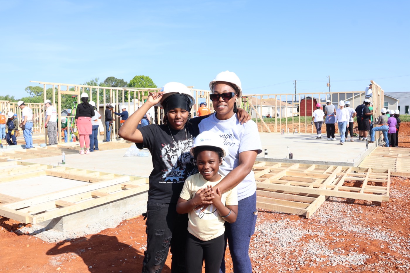 A partner family helps build their future home alongside volunteers